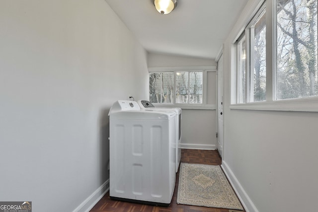 washroom with independent washer and dryer and dark parquet flooring