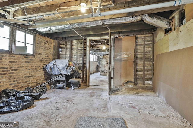 miscellaneous room with brick wall