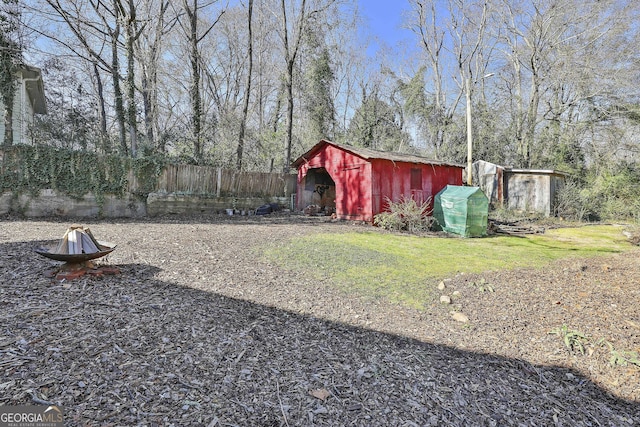 view of yard with a fire pit and a storage shed