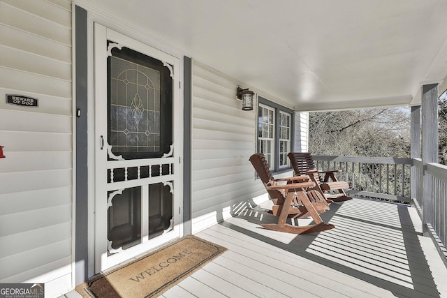 wooden terrace featuring a porch