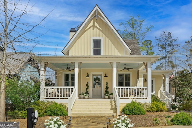 farmhouse featuring a porch, board and batten siding, a ceiling fan, and a chimney