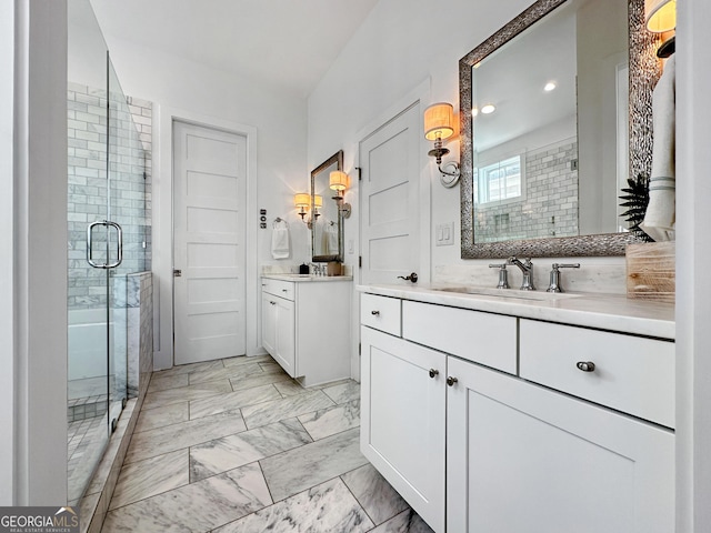 bathroom featuring vanity and a shower with door