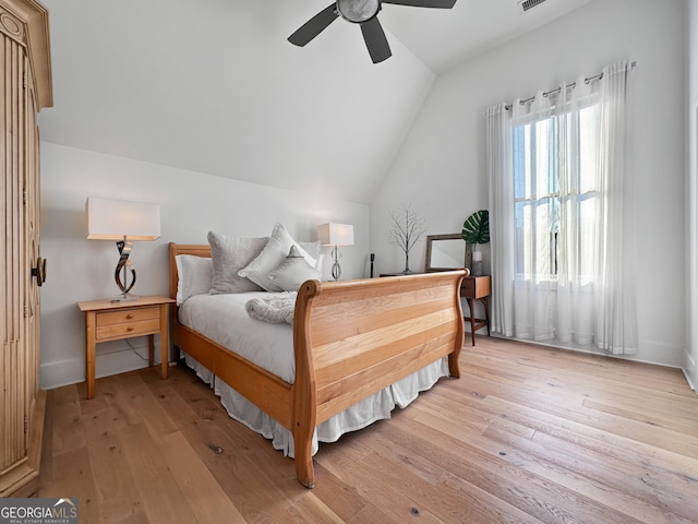 bedroom with light wood-type flooring, ceiling fan, and vaulted ceiling