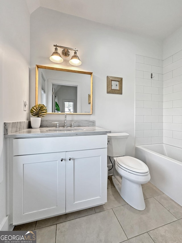 full bathroom with toilet, vanity, tiled shower / bath combo, and tile patterned flooring