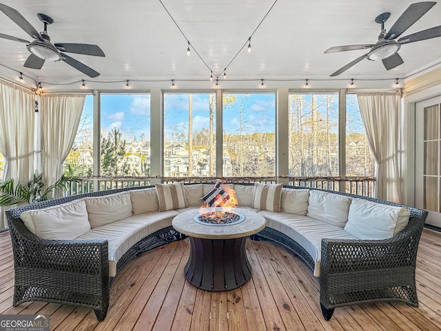 sunroom / solarium featuring ceiling fan