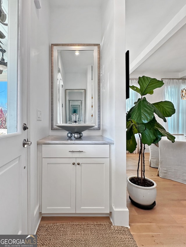 bathroom featuring hardwood / wood-style flooring and vanity