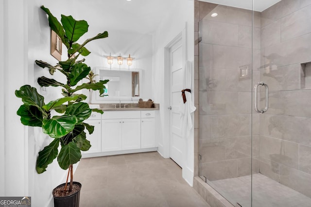 bathroom with a shower with door and vanity