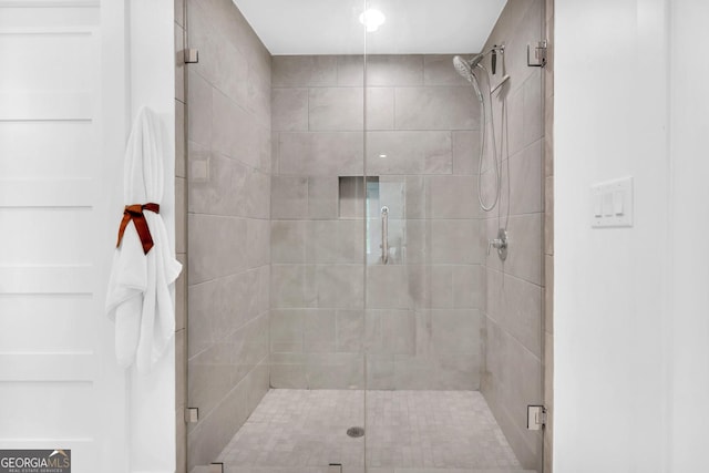 bathroom with a shower with shower door