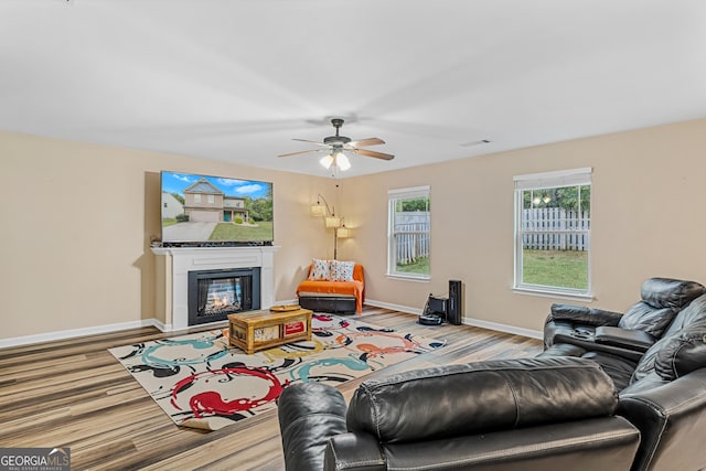 living room featuring light hardwood / wood-style floors and ceiling fan