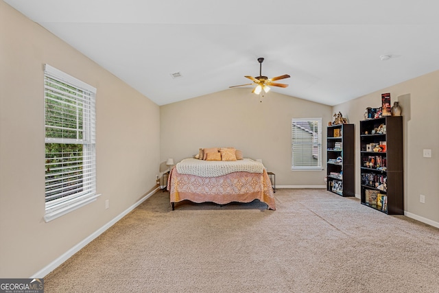 carpeted bedroom with ceiling fan and lofted ceiling