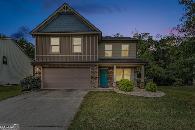 view of front of house with a garage and a lawn