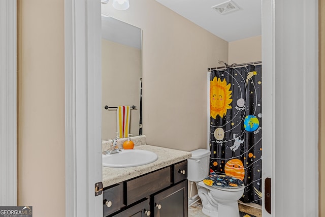 bathroom featuring curtained shower, toilet, and vanity