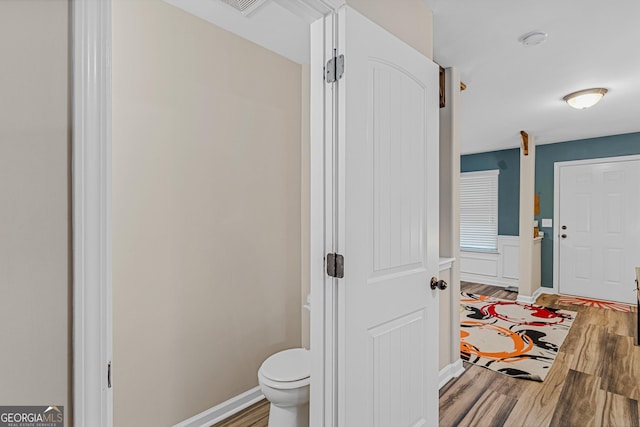 bathroom with toilet and wood-type flooring