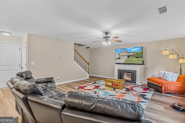 living room with ceiling fan and hardwood / wood-style floors