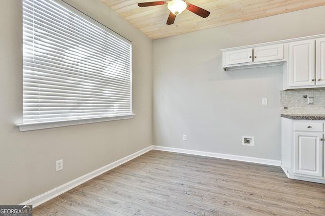 interior space featuring decorative backsplash, wooden ceiling, white cabinetry, and light wood-type flooring