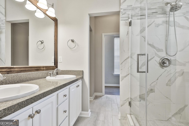 bathroom featuring an enclosed shower and vanity