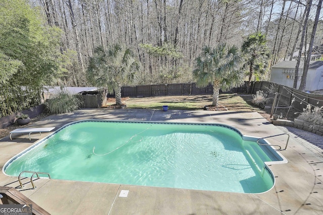 view of pool featuring a diving board