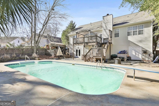 view of swimming pool featuring a pergola, a patio area, and a wooden deck