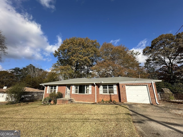 ranch-style home with a front yard, brick siding, driveway, and an attached garage