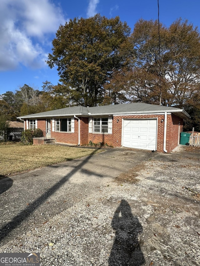 ranch-style home with driveway, an attached garage, and brick siding