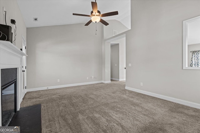 unfurnished living room featuring a glass covered fireplace, carpet flooring, visible vents, and baseboards