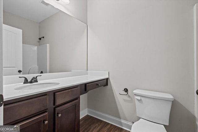 206 Glacier Ct, Carrollton, GA 30117 - bathroom with wood finished floors, vanity, toilet, a shower, and baseboards