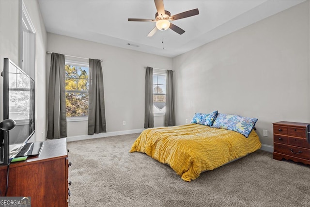 bedroom featuring carpet flooring, ceiling fan, visible vents, and baseboards