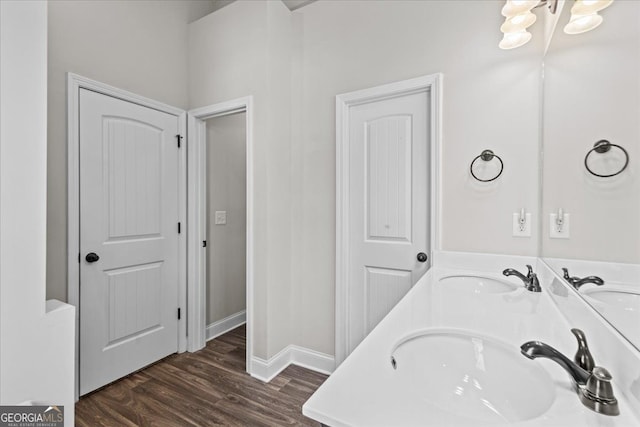 bathroom featuring double vanity, a sink, and wood finished floors