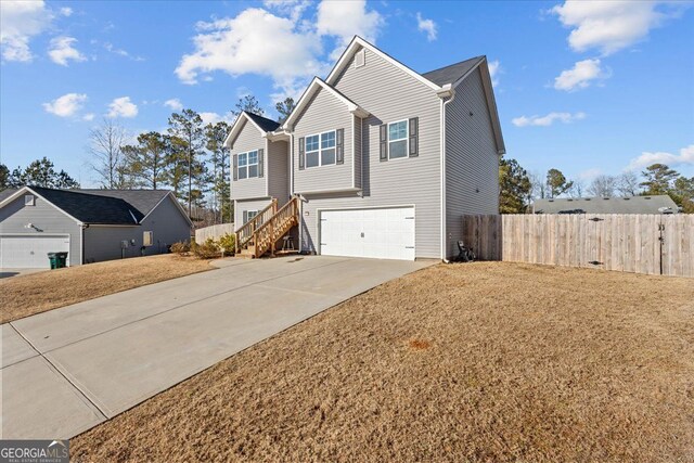 206 Glacier Ct, Carrollton, GA 30117 - view of home's exterior with concrete driveway, a garage, fence, and stairs