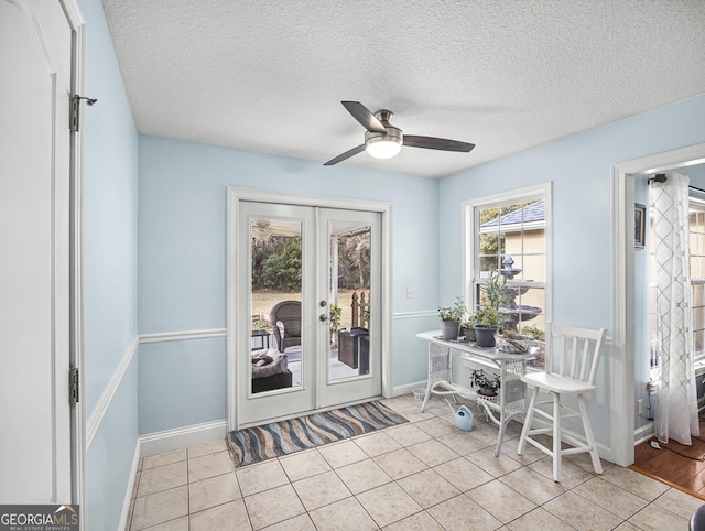 home office with ceiling fan, a textured ceiling, french doors, and light tile patterned flooring