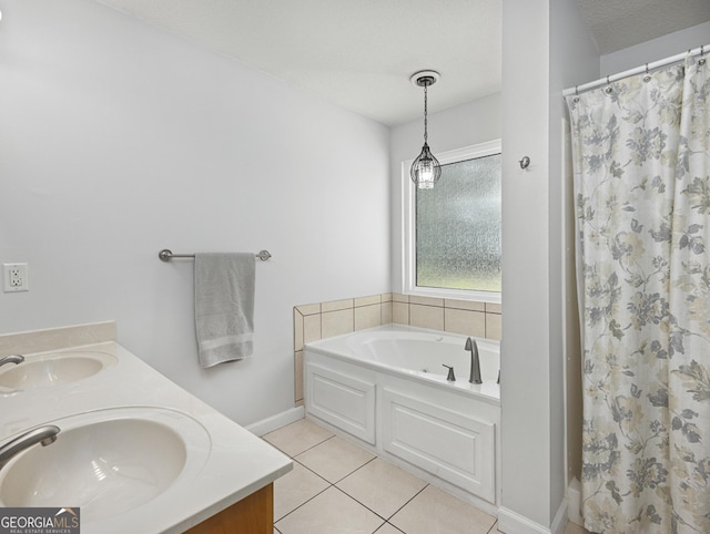 bathroom featuring vanity, independent shower and bath, tile patterned floors, and a textured ceiling