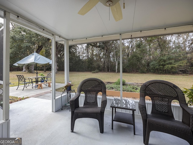 sunroom / solarium featuring ceiling fan and a wealth of natural light