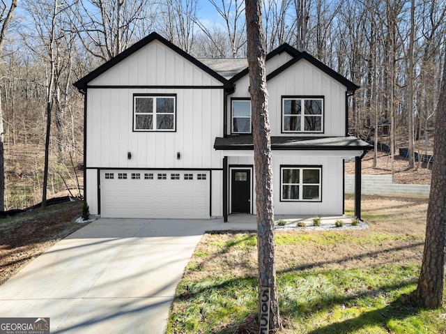 modern inspired farmhouse with an attached garage, concrete driveway, and board and batten siding