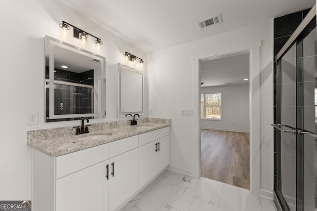 bathroom featuring visible vents, marble finish floor, baseboards, and a sink