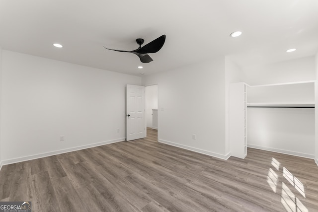 unfurnished bedroom with recessed lighting, baseboards, and wood finished floors