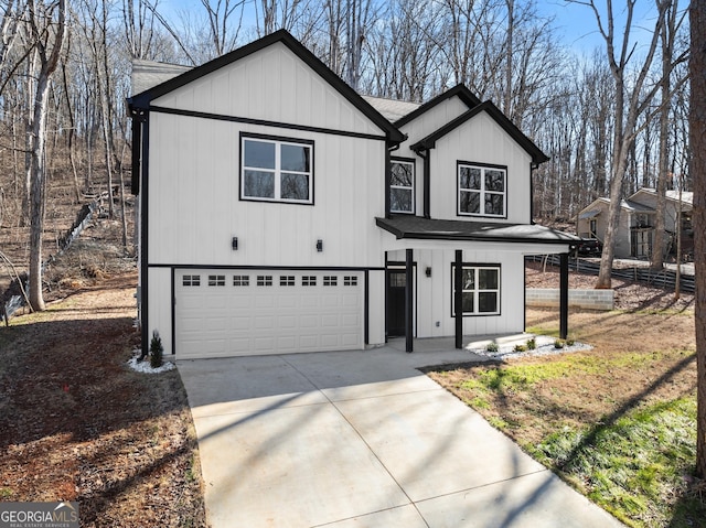 modern inspired farmhouse with covered porch, an attached garage, concrete driveway, and a shingled roof
