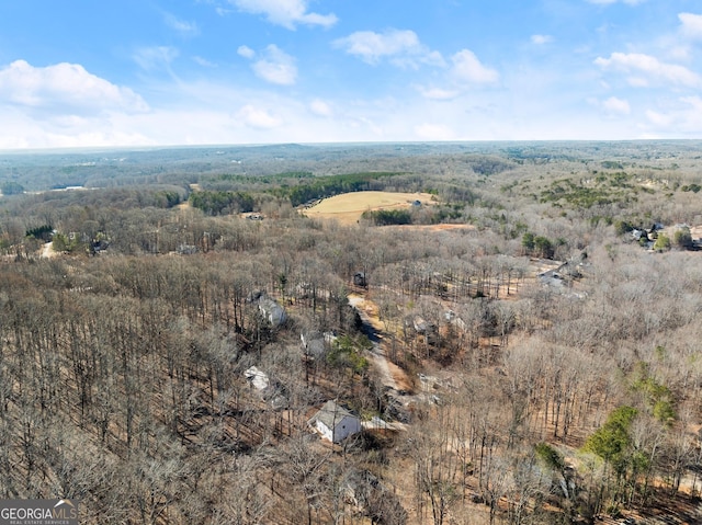 birds eye view of property featuring a wooded view