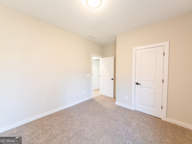 4392 Navajo Ln SE, Acworth, GA 30102 - unfurnished bedroom with baseboards and light colored carpet