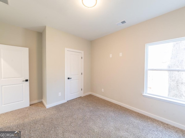 4392 Navajo Ln SE, Acworth, GA 30102 - unfurnished bedroom with visible vents, baseboards, and light carpet