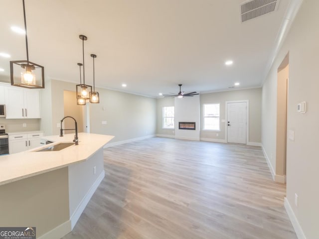 4392 Navajo Ln SE, Acworth, GA 30102 - unfurnished living room featuring a sink, ceiling fan, baseboards, visible vents, and recessed lighting