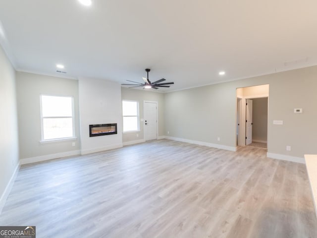 4392 Navajo Ln SE, Acworth, GA 30102 - unfurnished living room with a glass covered fireplace, a ceiling fan, baseboards, and recessed lighting