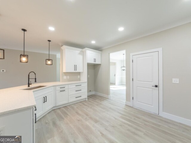 4392 Navajo Ln SE, Acworth, GA 30102 - kitchen with recessed lighting, a sink, light wood-style floors, hanging light fixtures, and white cabinetry