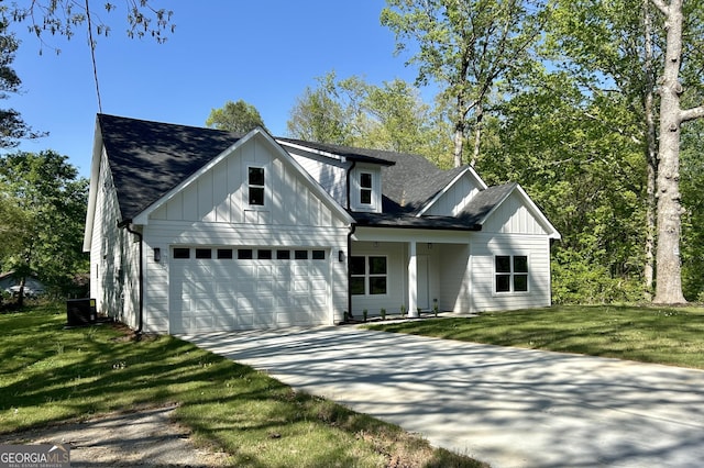 4392 Navajo Ln SE, Acworth, GA 30102 - view of front of house with a front lawn, driveway, a garage, a shingled roof, and board and batten siding