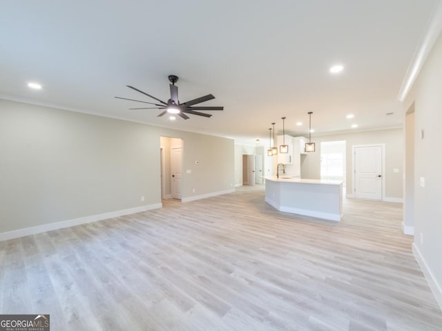4392 Navajo Ln SE, Acworth, GA 30102 - unfurnished living room featuring crown molding, ceiling fan, light wood finished floors, baseboards, and recessed lighting