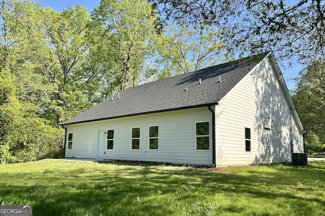 4392 Navajo Ln SE, Acworth, GA 30102 - back of house with a shingled roof, a yard, and central AC unit