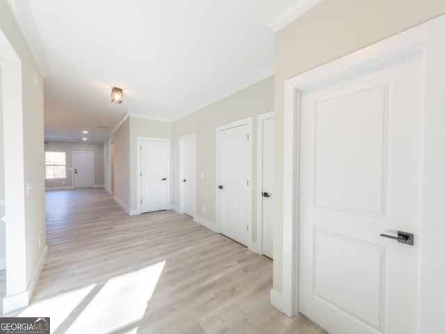 4392 Navajo Ln SE, Acworth, GA 30102 - hall featuring baseboards, light wood-style floors, and ornamental molding