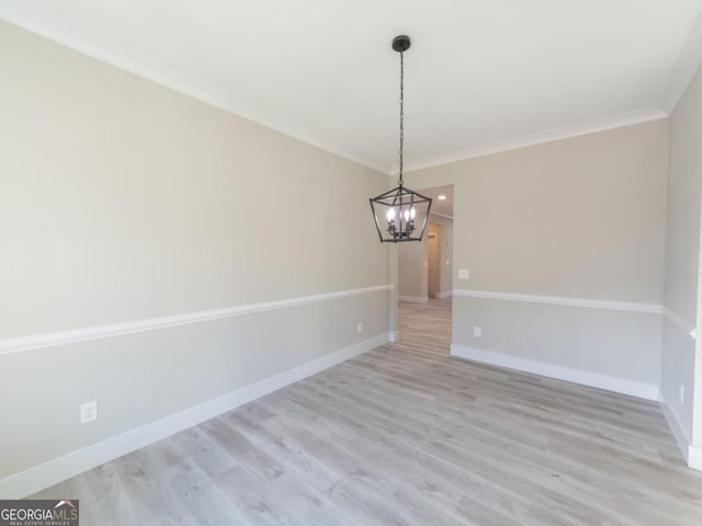 4392 Navajo Ln SE, Acworth, GA 30102 - unfurnished dining area featuring baseboards, ornamental molding, a chandelier, and light wood-type flooring
