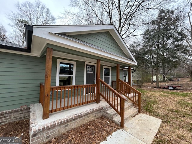 view of exterior entry with a porch