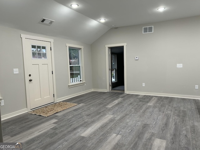 entrance foyer with dark wood-type flooring and vaulted ceiling