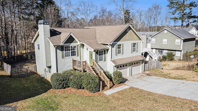 view of front of home with a front yard and a garage